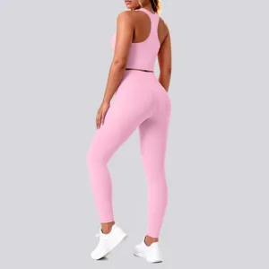 Pink seamless fitness yoga set detail view, comfortable high waist activewear leggings and bra.