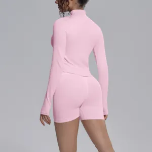 Pink seamless long sleeve activewear set with tight shorts for fitness, running, and yoga workouts.