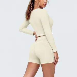 Seamless color block long sleeve crop top and high waist shorts yoga set for fitness and running.