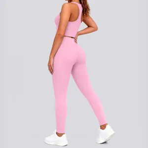Detailed view of women pink activewear set, athletic crop top and matching leggings for yoga.