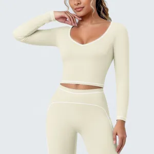 Dames sport langarm crop top bijpassende yoga leggings set voor fitness training hardlopen.