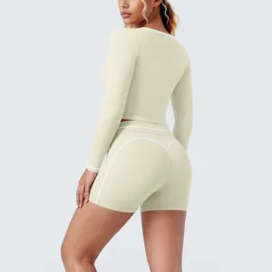 Detailed view of women's beige long sleeve crop top and shorts activewear set for fitness yoga.