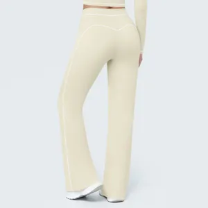 Detail view of high waist flared yoga pants with contrast piping, active sportswear style.