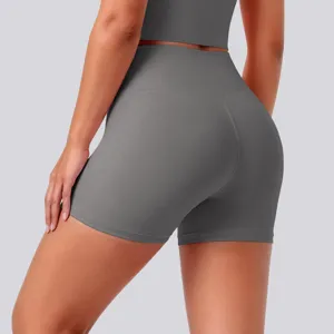 High-waisted tight yoga shorts detail shot, breathable nude fabric for fitness and running.