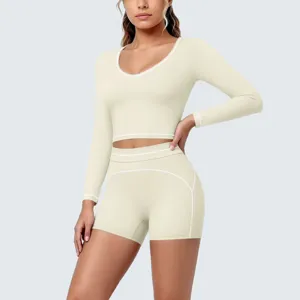 Women solid color long sleeve crop top and shorts activewear set for fitness and yoga.