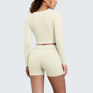 Back view detail of women long sleeve crop top and shorts yoga set with contrast piping.