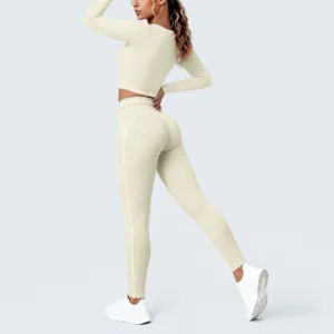 Back view detail of women solid beige crop top and high waist leggings with white piping.