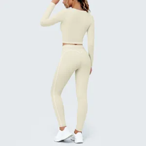 Beige long sleeve activewear set crop top and high waist leggings for yoga and fitness.