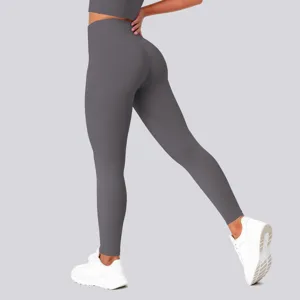 High-waisted dark grey yoga leggings detail shot, featuring stretch fabric and hip-lifting fit.