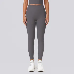 High-waist seamless dark gray yoga leggings detail view, showing stretch and body shaping.