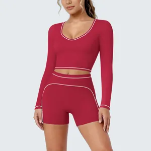 Close-up detail of women red long sleeve crop top sports shorts fitness yoga activewear set.