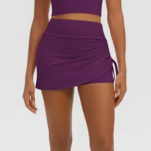 Detail view of the purple high-waisted ruched fake two-piece yoga skirt and active shorts.
