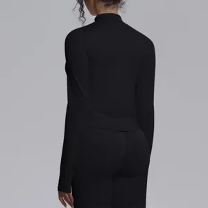 Black seamless long-sleeve yoga top and leggings set, back view detail showing fit.