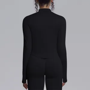 Detailed back view of a black seamless long sleeve yoga top and tight pants activewear set.