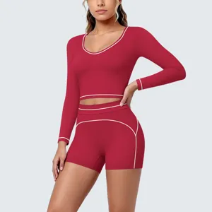 Detailed view of the red contrast piping long-sleeve crop top and matching athletic shorts.