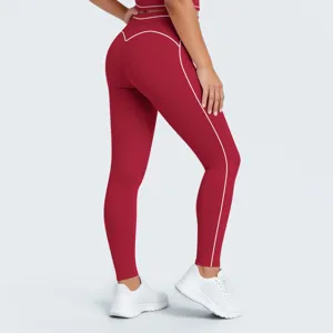 Vista detallada de pantalones de yoga rojos de talle alto, ribetes en contraste y tejido elástico.