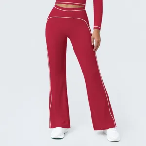 Close-up detail of the high-waisted flared yoga pants featuring stylish contrast white piping.