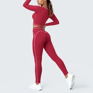 Red athletic crop top and leggings detail view, featuring contrast white piping for workout.