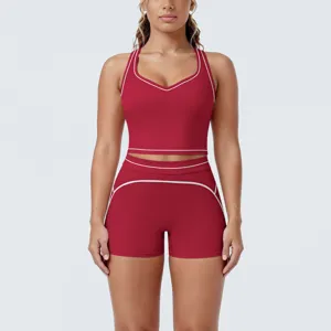 Detail view of the contrast piping yoga crop top and athletic shorts set in red.