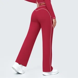 Back view detail of high-waisted red wide-leg active pants with stylish white piping trim.