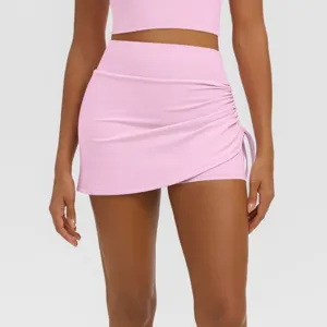 Detailed view of women pink athletic yoga skort, high waist ruched fitness running skirt.