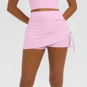 Pink ruched athletic yoga skort detail, high stretch breathable fabric for fitness and running.
