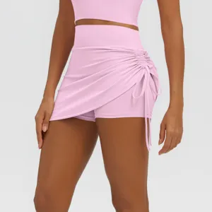 Detailed view of women pink high waist athletic skort with side drawstring ruched design.