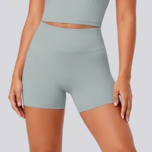 Detailed close-up of high-waisted tight yoga shorts in light grey, showing elastic fabric.