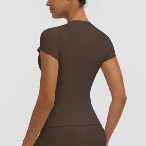Back view detail of the solid dark brown athletic short sleeve yoga top for women.