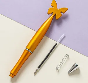 Detailed view of the cute butterfly top ballpoint pen components, showing refill and spring.