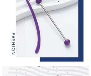 Close-up detail of DIY beaded metal bookmark with purple ends on clean wavy background.