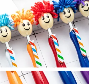 Colorful doll head novelty ballpoint pens with fluffy hair and cute smiling face designs.