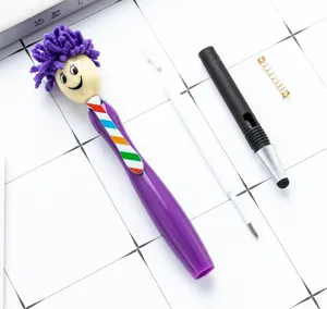 Detailed view of disassembled cute doll ballpoint pen parts including spring and refill.