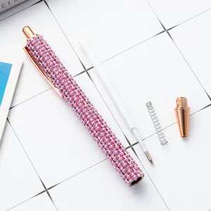 Luxury pink pearl rhinestone ballpoint pen with rose gold metal parts for office and gift use.