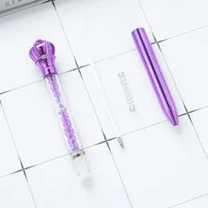 Purple crown crystal ballpoint pen disassembled parts display on grid background for office.