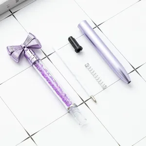 Purple plastic crystal bow ballpoint pen disassembled display for promotional gift use.