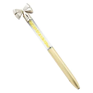 Elegant gold bow crystal ballpoint pen with sparkling yellow diamonds for gift and office.