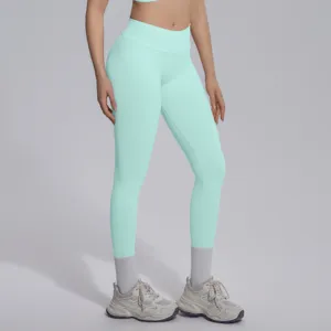 Mint green seamless knit high V-waist yoga leggings, detailed view showing stretch and fit.