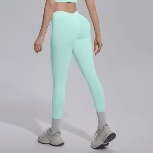 Seamless knit V-waist butt lifting yoga pants in mint green, detail view of fitness activewear.