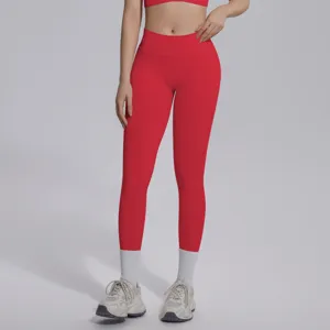 Detailed view of red seamless fitness leggings featuring high V-waist design and breathable fabric.
