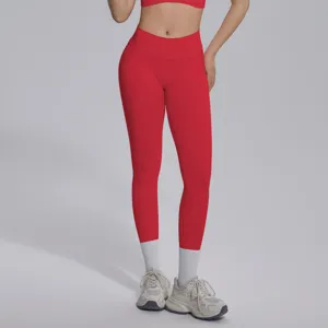 Seamless knit red V-waist tight breathable butt lifting yoga pants close up detail view.