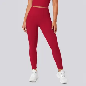 High-waisted red yoga leggings detail view, showing seamless fit, high elasticity and shaping design.