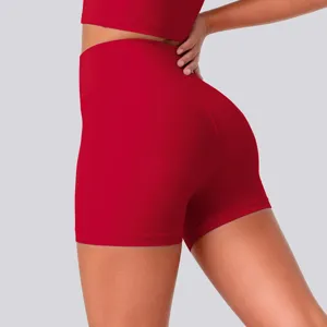 Close-up of high-waisted red yoga shorts featuring stretch fabric for optimal fitness comfort.