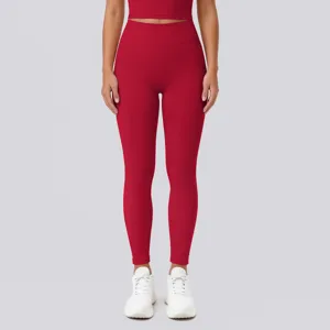 High waist seamless stretch red yoga pants detail view, breathable athletic wear close-up shot.