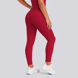 High waist red yoga leggings detail view, showing hip lifting fit and stretch activewear fabric.
