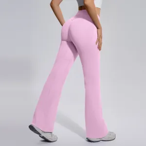 Detailed view of the pink crossover waist flare yoga pants showing stretchy seamless fabric.