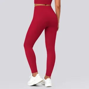 High-waisted solid red yoga leggings detail view, showing stretch fabric and fitted hip contour.