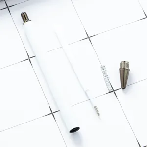White retractable ballpoint pen with metal tip and spring, clean office stationery flatlay.