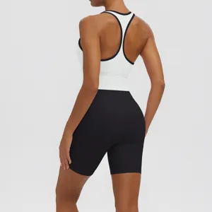 Detailed view of women activewear yoga set featuring a white racerback bra and black fitness shorts.