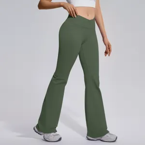 Detail view of high-waist crossover flare yoga pants, featuring stretchy green fabric.